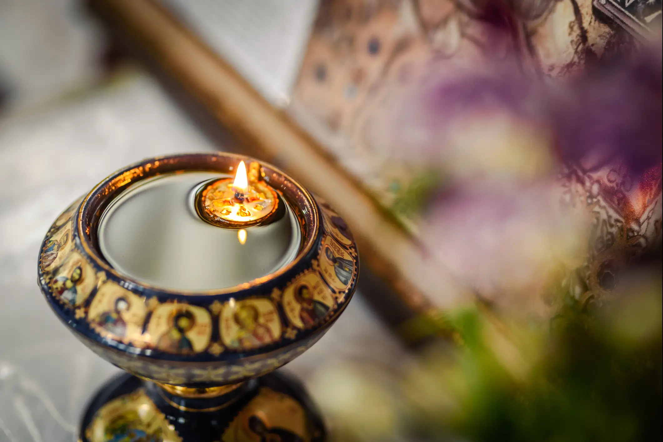 Decorative candle holder with small flame.