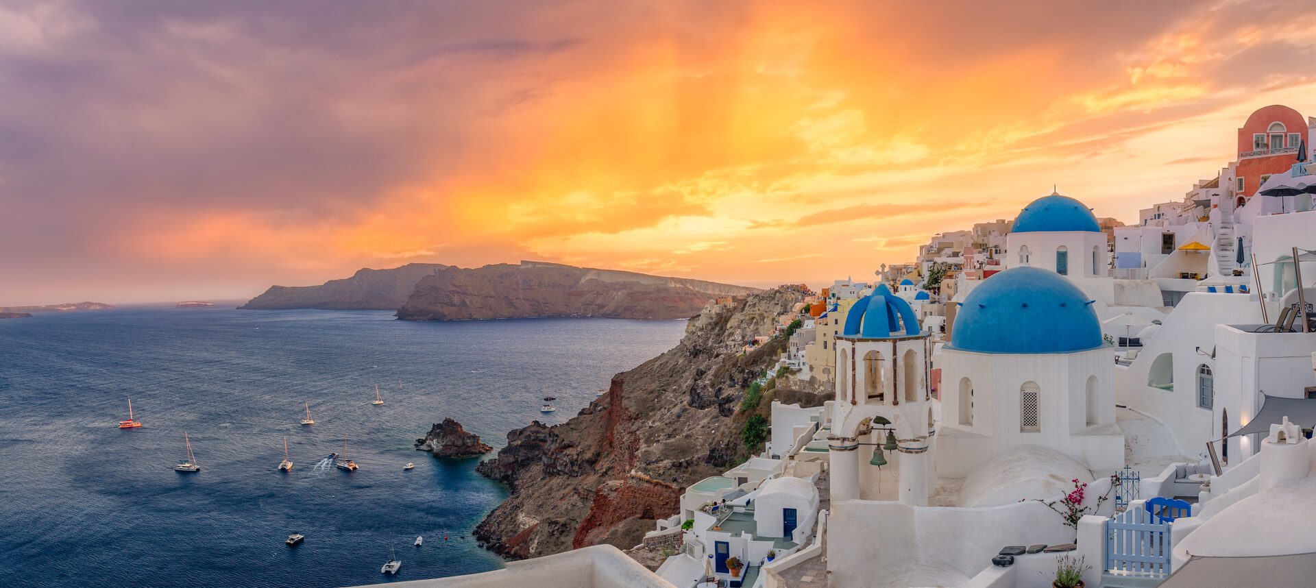 Santorini village with blue domes at sunset