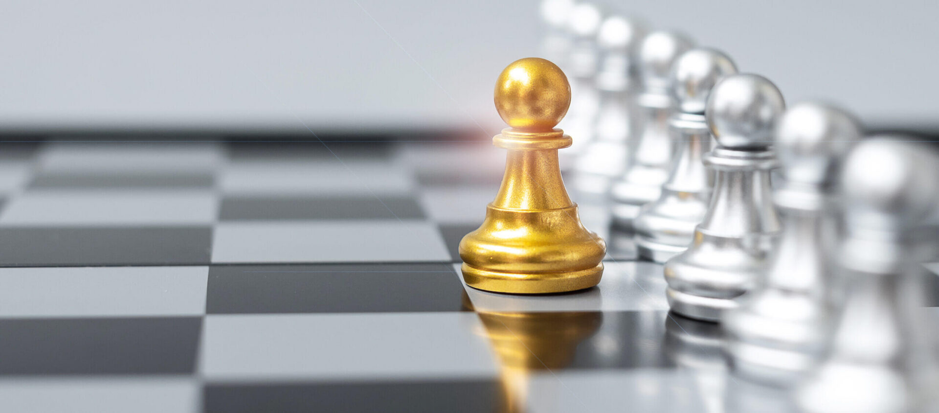 Golden pawn leading row of silver pawns