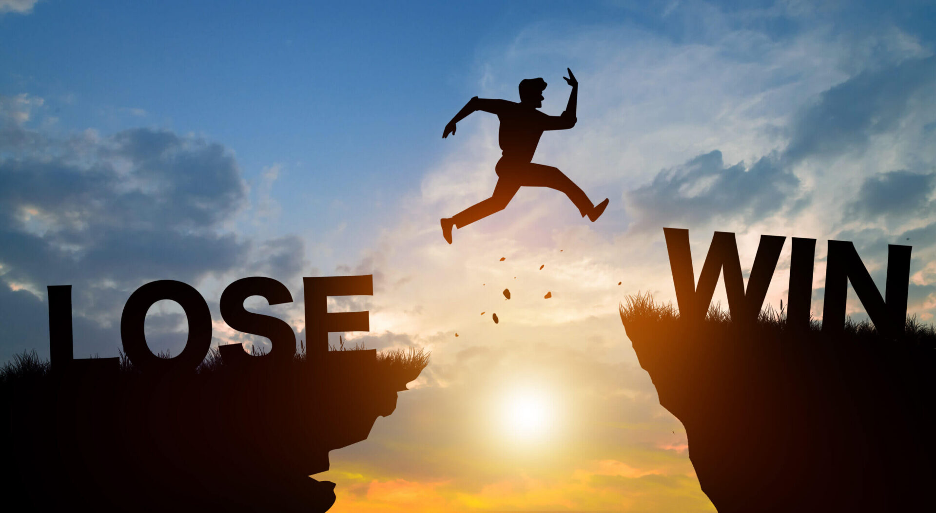 Silhouette jumping from "lose" cliff to "win