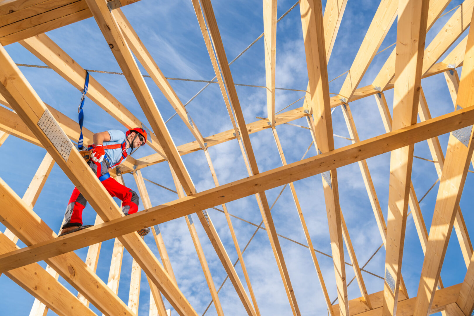 Construction worker on roof trusses