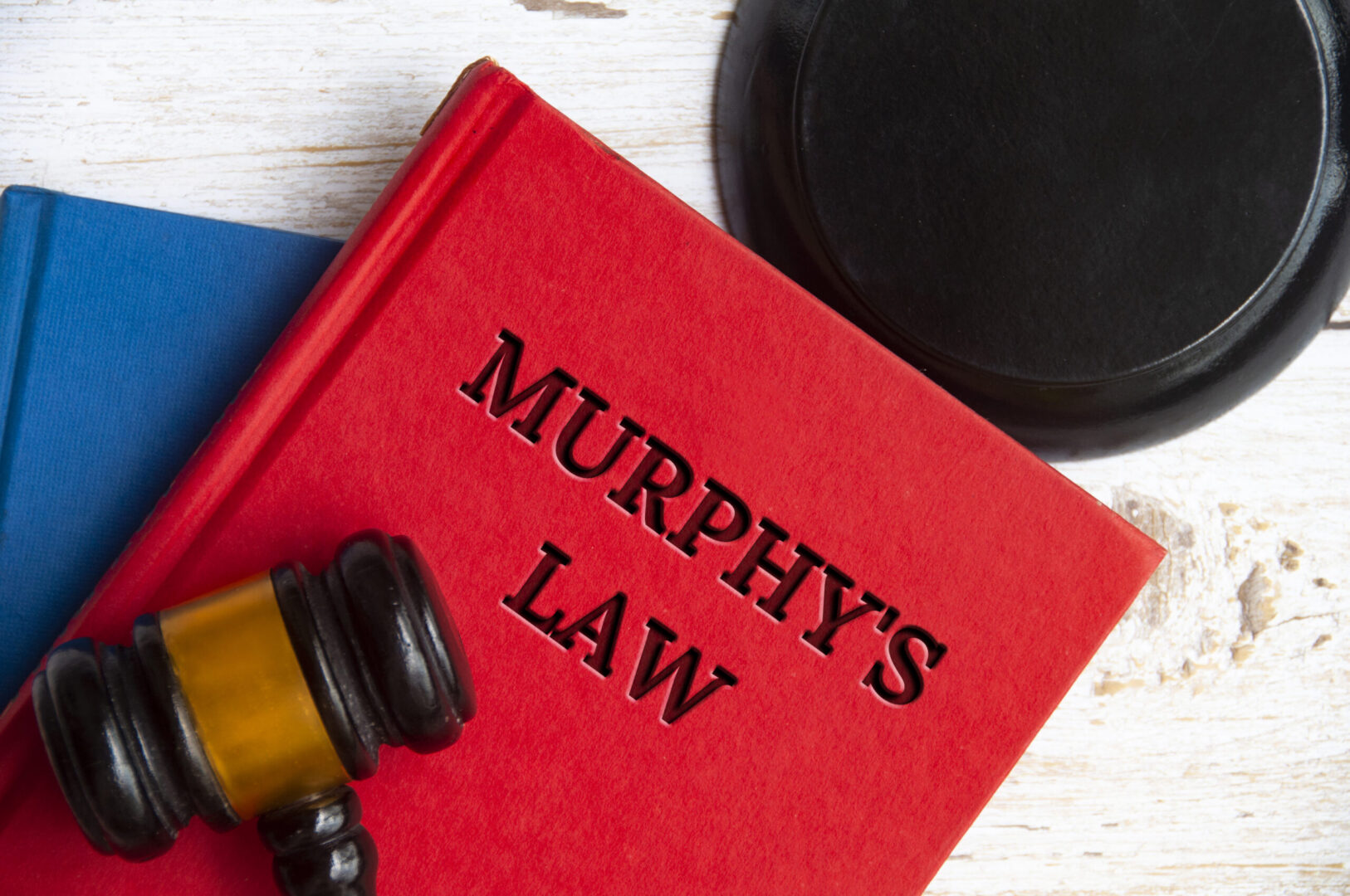 Gavel resting on red Murphy's Law book