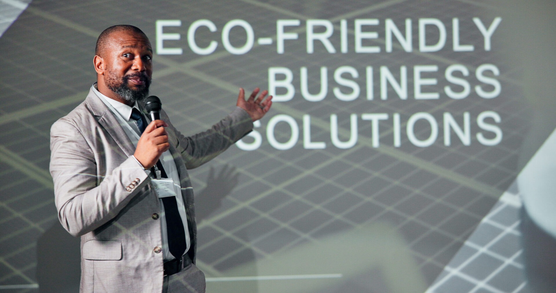 Speaker presenting eco-friendly business solutions slide