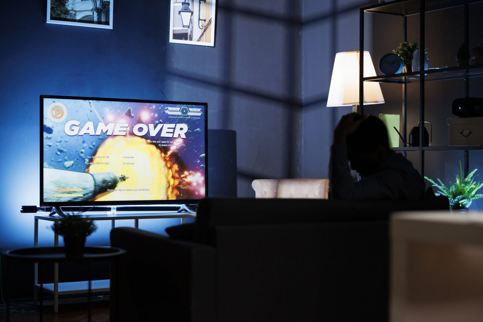 TV screen showing large "Game Over" text