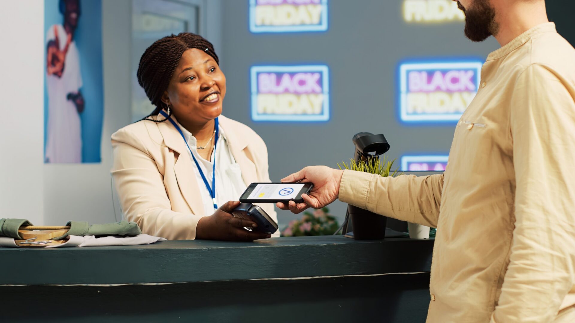 Cashier accepting mobile payment from customer