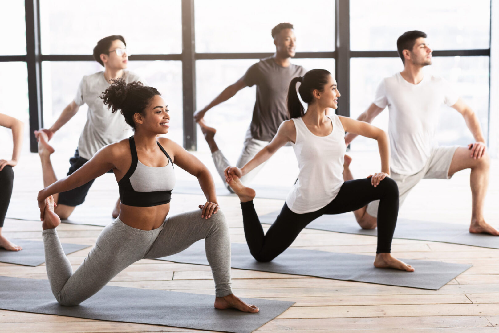 Group yoga class stretching in studio